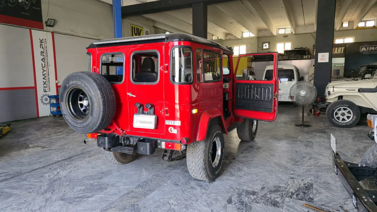 Workshop bay with vehicle service work at Fixmycar.pk